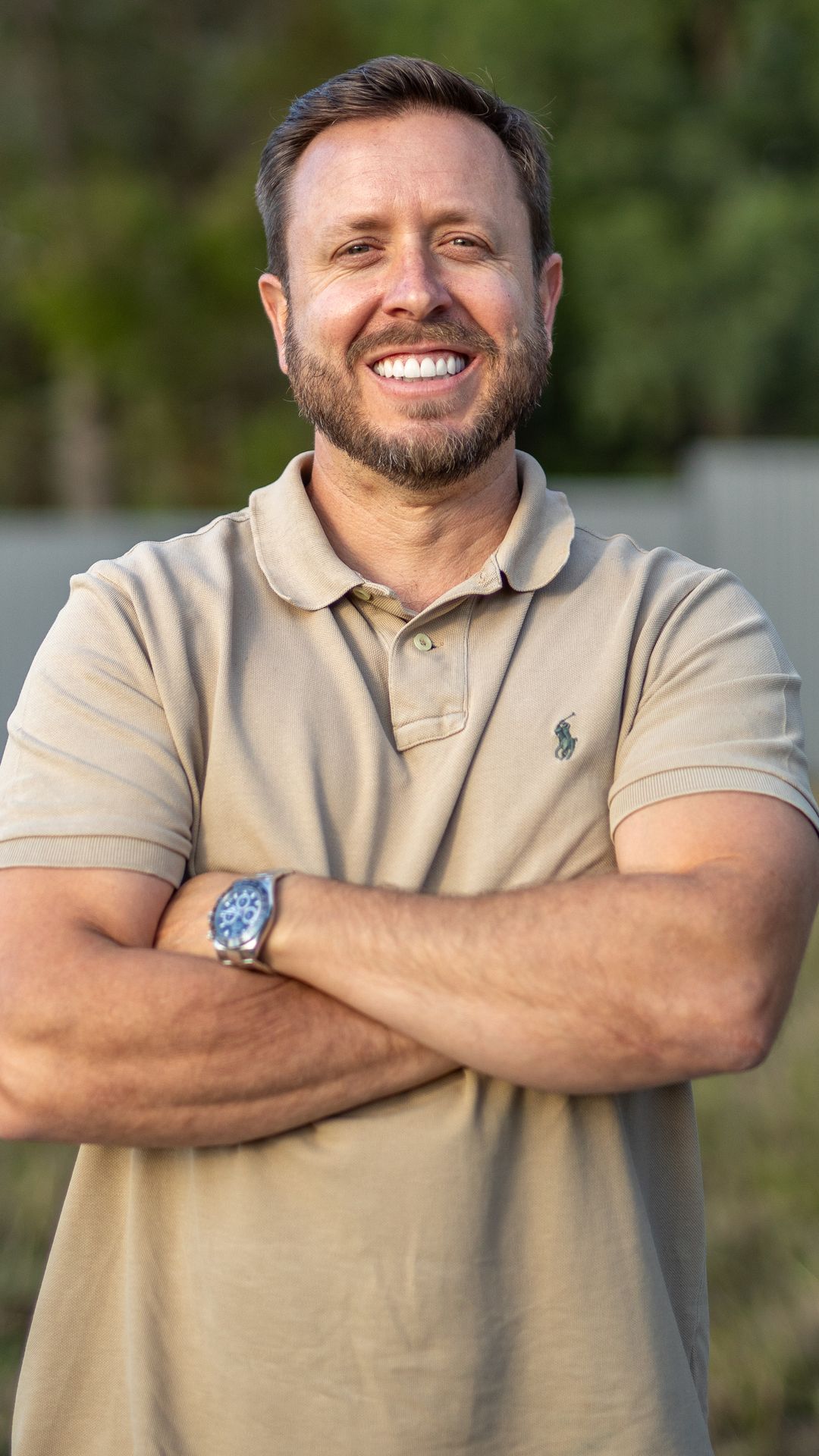 Ramon Palomar, arms crossed, on site at an estate
